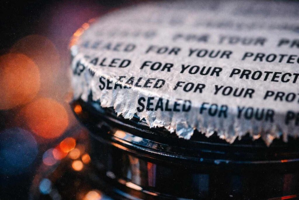 Checking the tamper-proof seal on a vegan omega 3 bottle for signs of tampering